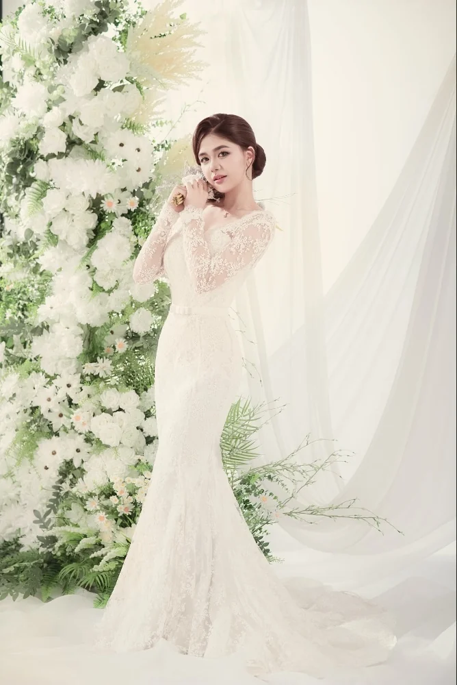 Bridal portrait surrounded by soft green foliage